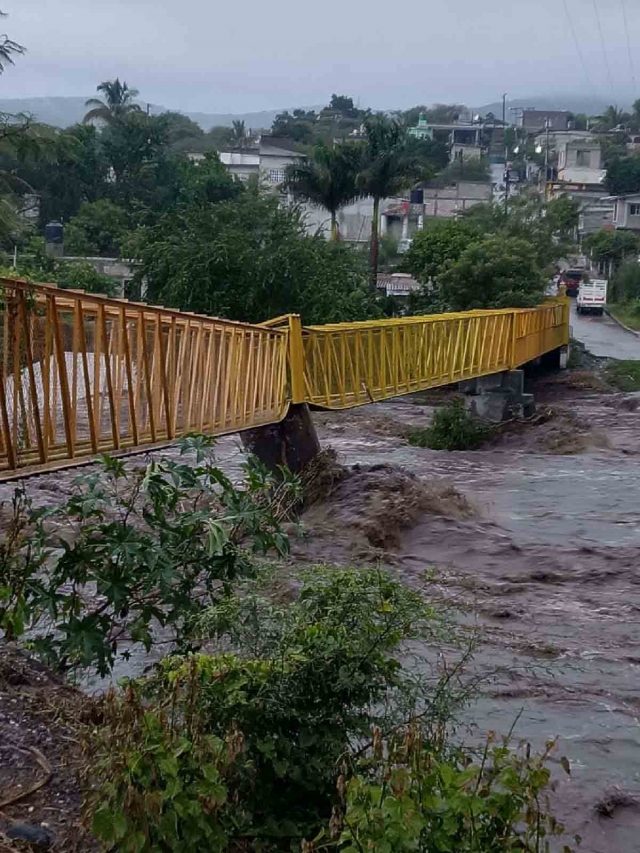 Un puente peatonal resultó dañado por la fuerza del río.